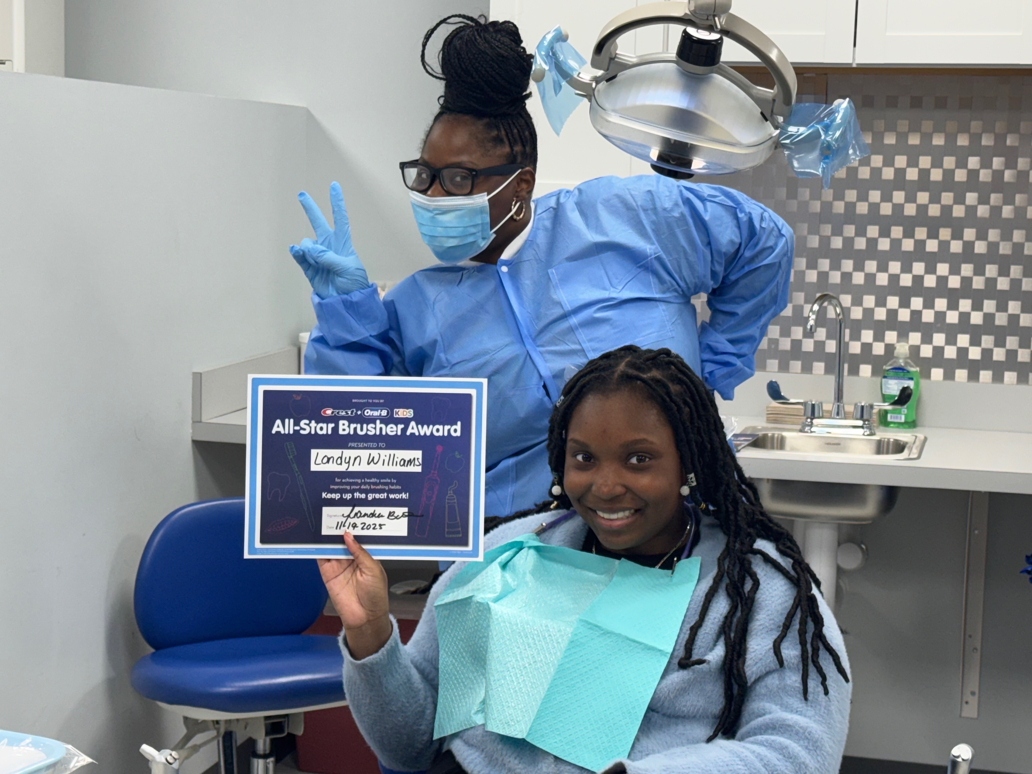 MCC ESL student and visitor showing Good Dental Brushing Certificate
