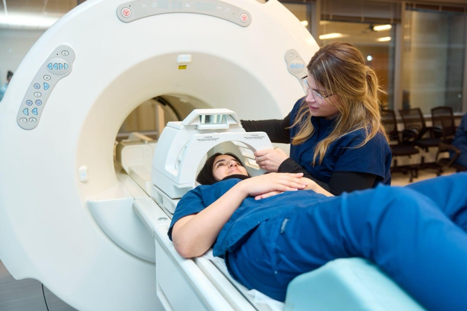 Midwestern Career College MRI Technology students practicing on an MRI simulator