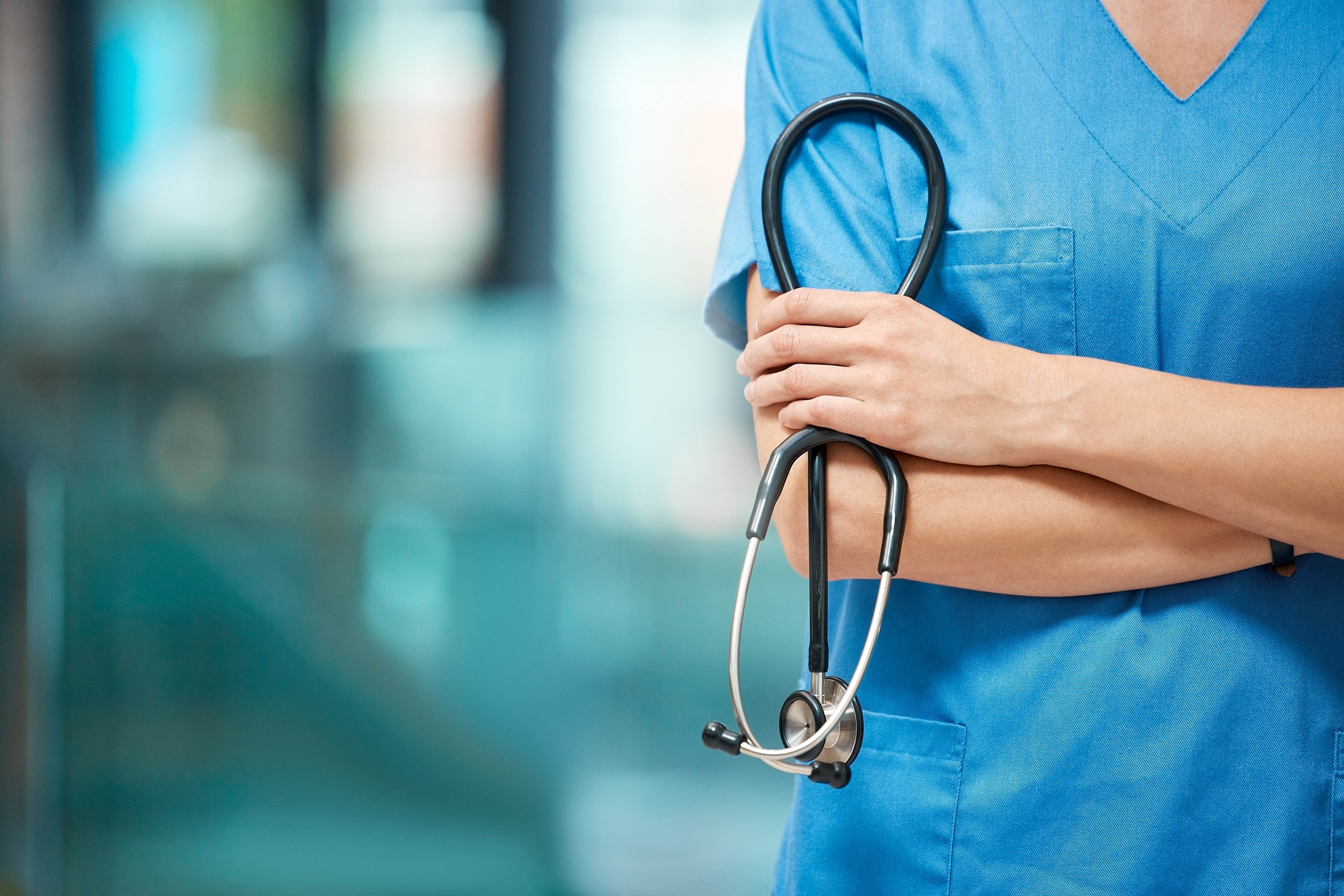 Nurse standing in a hospital corridor with arms crossed and a stethoscope, representing the Licensed Practical Nursing profession in Chicago