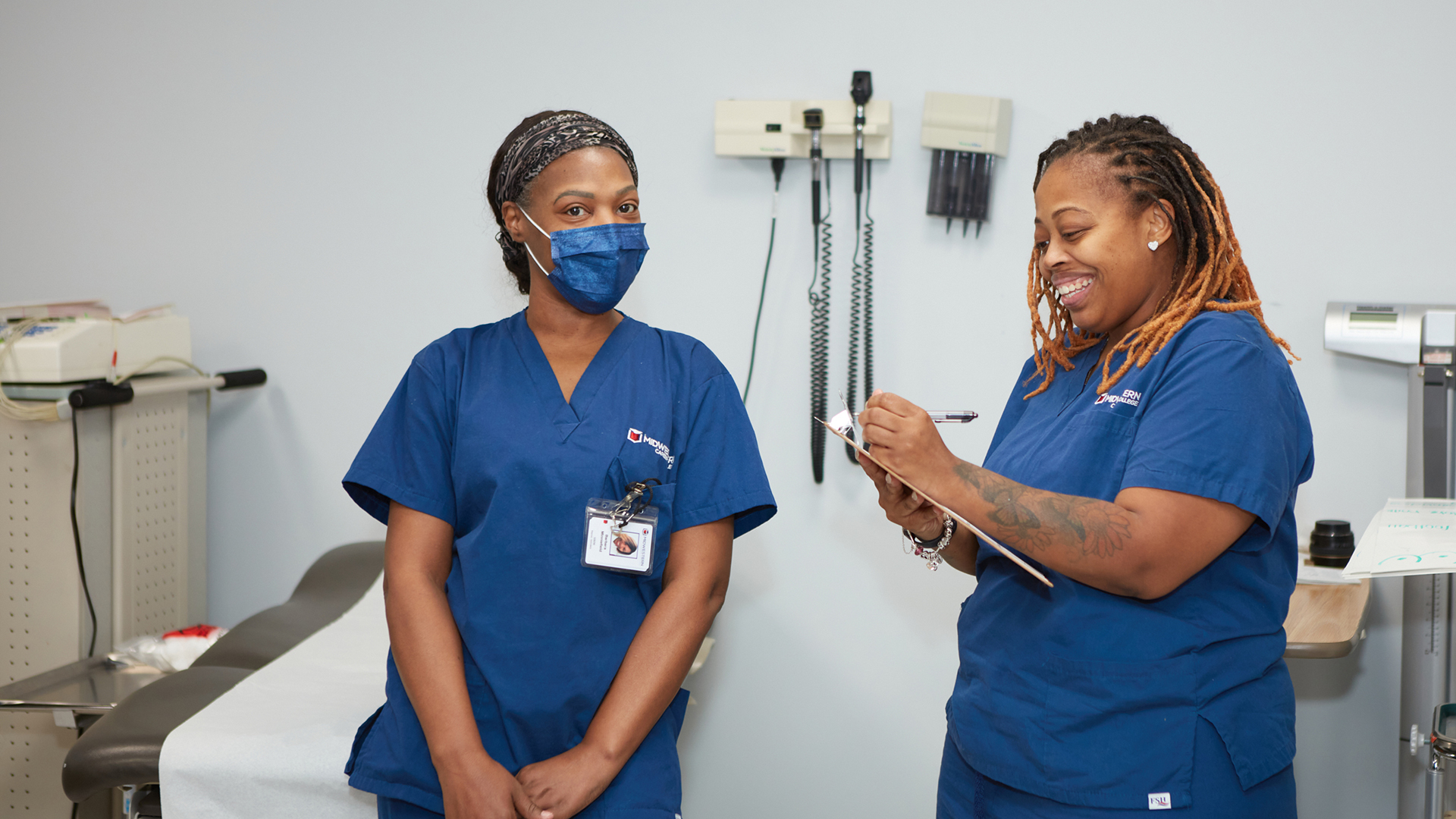 Clinical Medical Assisting students practicing patient care skills in a medical lab at Midwestern Career College in Chicago