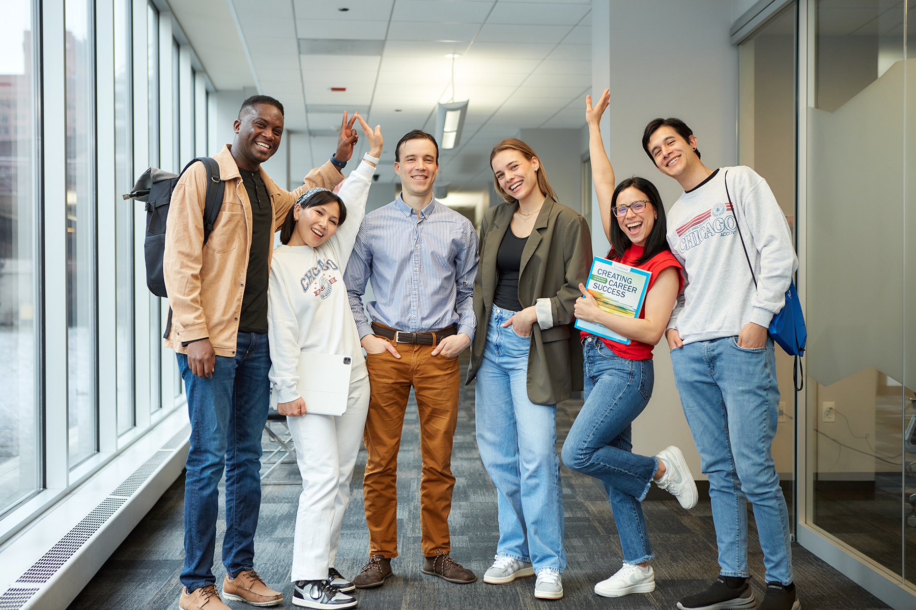 Smiling ESL students in the campus hallway at MCC.