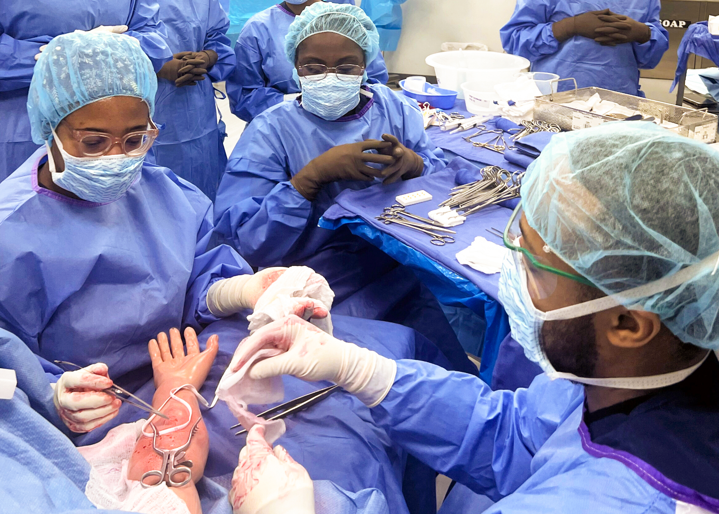 MCC Surgical Technology students practicing sterile technique during a vascular surgery simulation in a lab setting